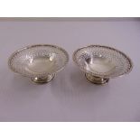 A pair of silver circular pierced bonbon dishes on raised circular bases, Birmingham 1962