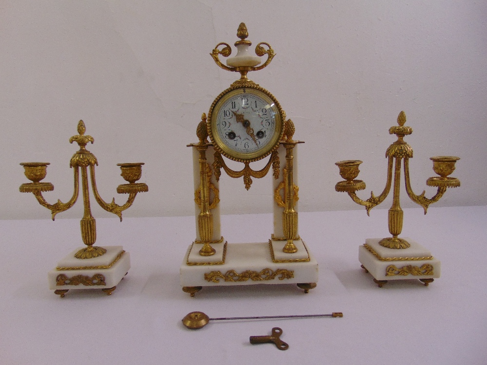 Leroy gilded metal and white marble clock set, white enamel dial, Arabic numerals, two train