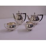 A silver four piece teaset of plain baluster form with bud finials to hinged covers, Chester 1941