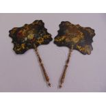 A pair of Victorian hand painted wooden hand held fire guards with turned wooden handles