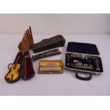 A quantity of musical instruments to include a miniature violin and bow in fitted case, two