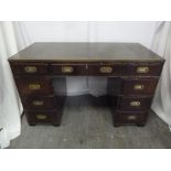A rectangular mahogany pedestal desk with inset brass handles and tooled leather top