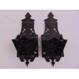 A pair of late 19th century carved and pierced ebonised wall brackets in the aesthetic style