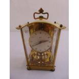 A Schatz gilt metal and glass revolving pendulum 8 day mantle clock with pierced carrying handle