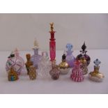 Fifteen decorative coloured glass perfume bottles of varying shape, form and size