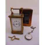 A brass carriage clock of customary form in fitted leather carrying case, to include key and a