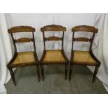 Three Regency mahogany inlaid dining chairs with bergere seats on tapering cylindrical legs, A/F