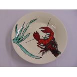 A Poole pottery charger decorated with a lobster, marks to the base