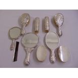 A silver mounted Art Nouveau style dressing table set comprising three hand mirrors, a pair of
