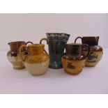 Five Doulton Lambethware jugs of varying shape and form