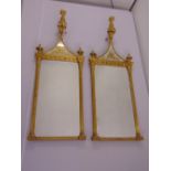 A pair of neo-classical rectangular wall mirrors surmounted by pineapple finials