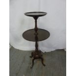 A mahogany circular tea table on four scroll legs