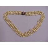 A three row pearl necklace with 18ct white gold, ruby and pearl clasp