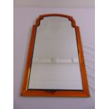 An Art Deco style shaped rectangular wall mirror with amber faceted glass border
