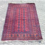 Persian wool carpet red ground with repeating geometric motifs and border, 132 x 100cm