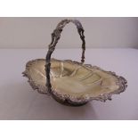 A Victorian silver fruit basket, oval, lobed sides with leaf scroll border and swing handle on