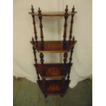 A Victorian four tier mahogany whatnot with turned baluster columns on four block feet