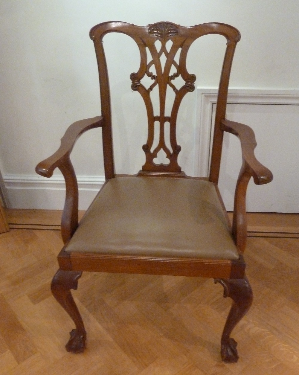 A Chippendale style mahogany armchair, pierced slatted back and scroll legs