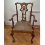 A Chippendale style mahogany armchair, pierced slatted back and scroll legs