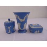 Three Wedgwood blue Jasperware pieces to include a vase, a rectangular covered box and a circular