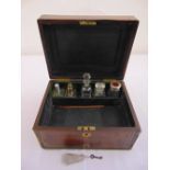 A Victorian mahogany rectangular travel vanity case, the hinged cover opens to reveal five glass
