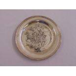 A silver limited edition circular salver depicting figures in a sleigh with horses designed by