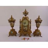 A late 19th century French clock set, gilded metal case with circular enamel dial and applied