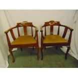 A pair of mahogany armchairs with upholstered seats, slatted backs, on cabriole legs