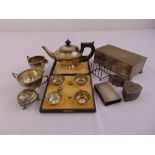 A quantity of silver and white metal to include salts, a cigarette box, a miniature tea set, a toast