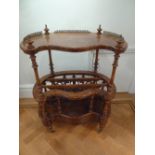 A Victorian walnut and mahogany kidney shaped whatnot with turned columns on four supports with