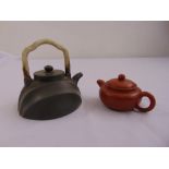 A Chinese terracotta teapot and another with carved jade handle