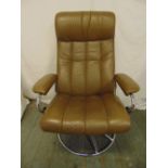 A 1980s leather and chrome armchair revolving recliner