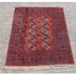 Persian wool carpet burnt orange ground with repeating geometric pattern and border, 185 x 144cm
