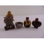 Two oriental glass snuff bottles, a carved jadeite figurine and a cloisonné bowl (4)