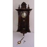 A Viennese wall regulator with white enamel dial, Roman numerals, to include key and pendulum