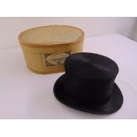 A black silk top hat by F.A. Dunn & Co. Ltd in original packaging