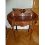 A kingswood shaped oval inlaid desk with gallery and six drawers on cabriole legs