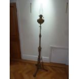 A Victorian free standing brass oil lamp, the knopped stem on three scroll legs
