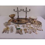 A quantity of silver plate to include trays, a pair of candelabra, place mat coasters and flatware