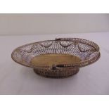 A George III silver shaped oval roll basket with bar pierced sides, rosettes and swags, beaded