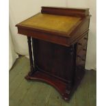 A rectangular mahogany Davenport with tooled leather top and four drawers on shaped rectangular