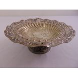 A silver cake stand, circular, scroll pierced and fluted on raised circular base, Birmingham 1906