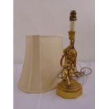A gilded metal figural table lamp stand in the form of a boy, on raised octagonal base, to include