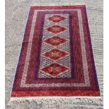 Persian wool carpet with geometric repeating pattern and border, predominately reds, blues and