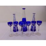 Three Baccarat blue overlaid glass decanters and six matching glasses (no drop stoppers included)