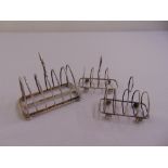 A pair of silver toast racks, wirework with heart shaped divisions on four ball feet, Sheffield 1927