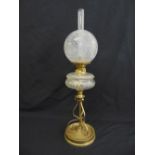 A Victorian brass and clear glass oil lamp on raised circular base