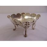 A silver sweetmeat dish, square with scroll border, lion mask ring side handles on four leaf