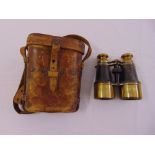A pair of leather and brass binoculars circa 1910 in fitted leather case