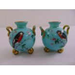 A pair of 20th century vases of globular form, the sides decorated with birds, scroll handle on